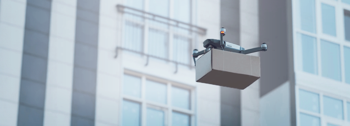 Modern delivery drone with shipping box delivering to apartment building